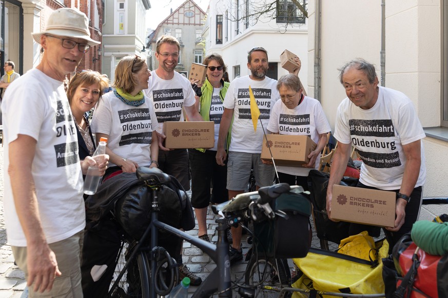23 April 2019, Lower Saxony, Oldenburg: Participants of the so-called Schokofahrt together with Mayor Christine Wolff (Bündnis90/Die Grünen, 2nd from left) invite chocolate from their bicycles in the  ...