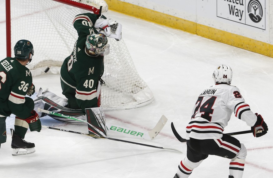 Chicago Blackhawks&#039; Dominik Kahun, right, of the Czech Republic, scores a goal against Minnesota Wild goalie Devan Dubnyk during the first period of an NHL hockey game Thursday, Oct. 11, 2018, in ...