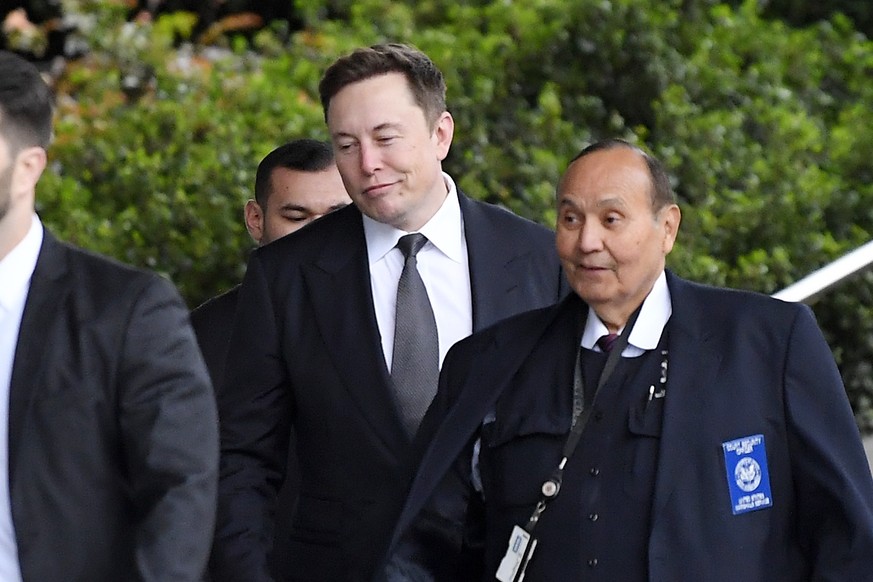 Tesla CEO Elon Musk, second from right, arrives at U.S. District Court Wednesday, Dec. 4, 2019, in Los Angeles. Musk is going on trial for his troublesome tweets in a case pitting the billionaire agai ...