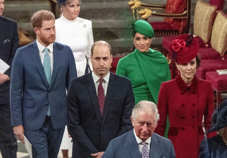 FILE - In this file photo dated Monday March 9, 2020, from back, Britain&#039;s Prince Harry and Meghan Duchess of Sussex, Prince William and Kate, Duchess of Cambridge, with Prince Charles, front, as ...