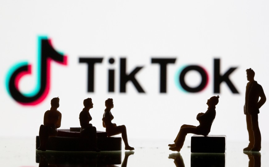 Small toy figures are seen in front of a Tiktok logo in this illustration taken, September 9, 2020. REUTERS/Dado Ruvic/Illustration