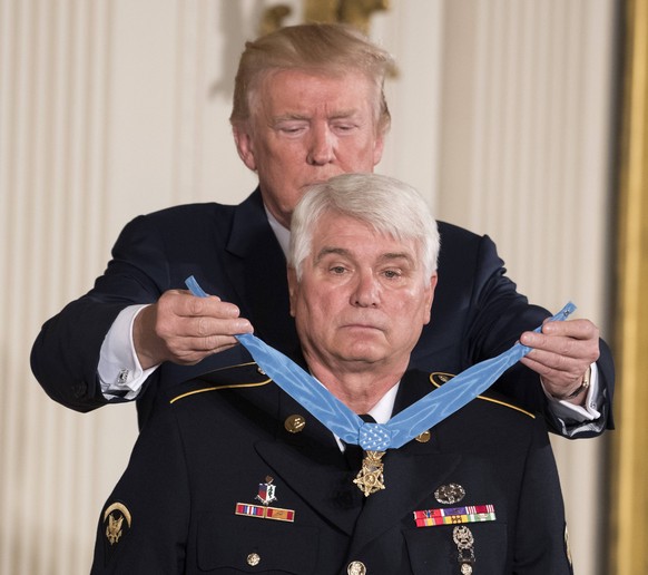 U.S. President Donald Trump awards the Medal of Honor to James McCloughan during a ceremony in the East Room of the White House in Washington, DC on July 31, 2017. McCloughan was an U.S. Army medic wh ...