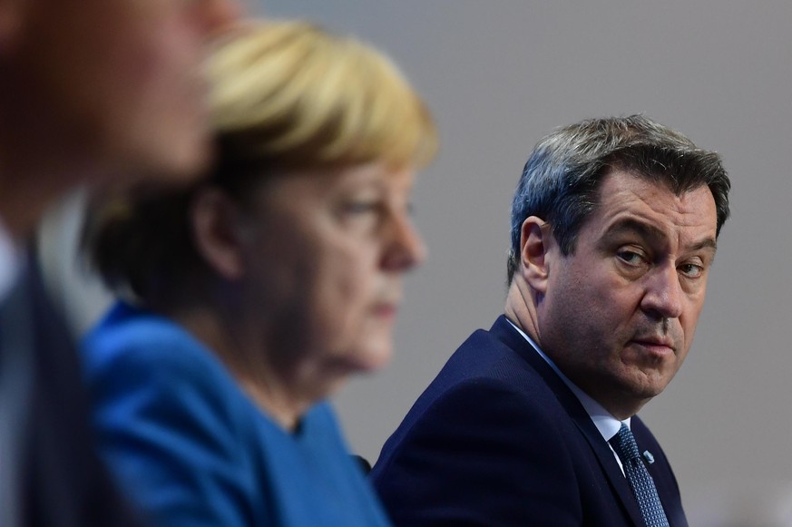 BERLIN, GERMANY - OCTOBER 28: (L-R) German Chancellor Angela Merkel and Premier of Bavaria Markus Soeder attend a press conference after a video conference with German State Premiers about the current ...