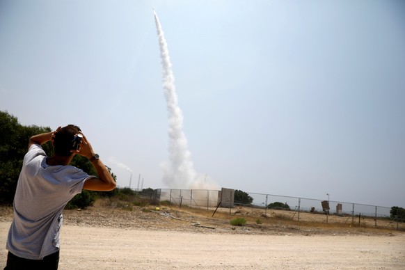 An Israeli man looks on as an Iron Dome launcher fires an interceptor rocket in the southern Israeli city of Ashkelon July 14, 2018 REUTERS/Amir Cohen TPX IMAGES OF THE DAY