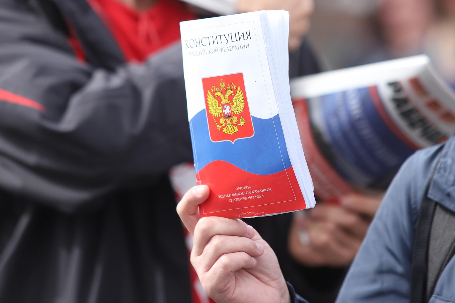 July 1, 2020, Saint-Petersburg, Russia: A man holding a Russian Constitution during a protest against constitutional amendments..1 July is the main day of voting on the constitutional amendments that  ...