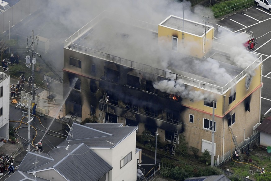 Smoke billows from a three-story building of Kyoto Animation in a fire in Kyoto, western Japan, Thursday, July 18, 2019. Kyoto prefectural police said the fire broke out Thursday morning after a man b ...