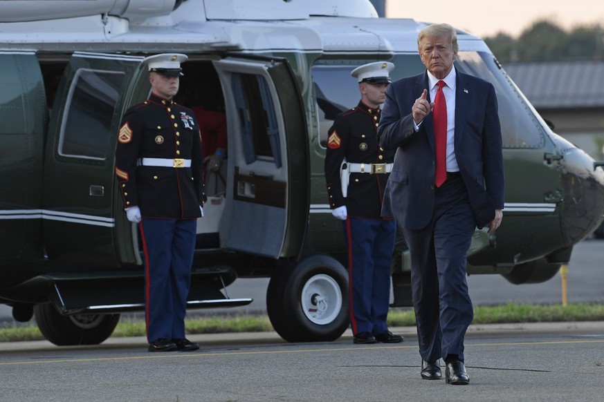 President Donald Trump walks off of Marine One and heads over to talk with reporters before departing from Morristown Municipal Airport in Morristown, N.J., Sunday, Aug. 9, 2020. Trump was returning t ...