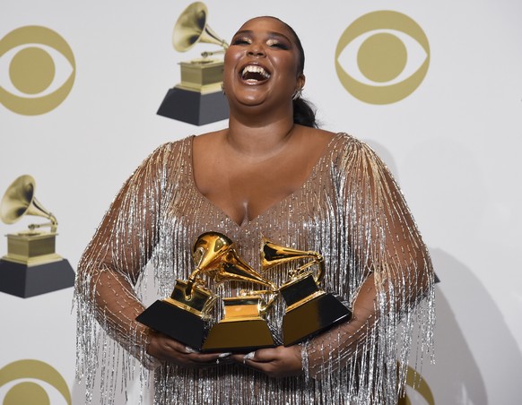 Lizzo poses in the press room with the awards for best pop solo performance for &quot;Truth Hurts&quot;, best urban contemporary album for &quot;Cuz I Love You&quot; and best traditional R&amp;B perfo ...