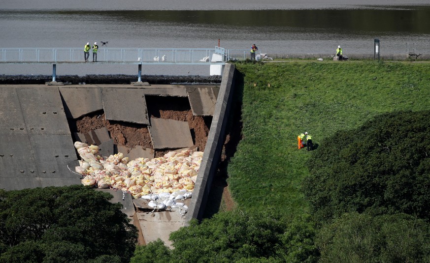 Workers use a drone to observe the damaged section of the dam in Whaley Bridge, Britain August 2, 2019. REUTERS/Phil Noble