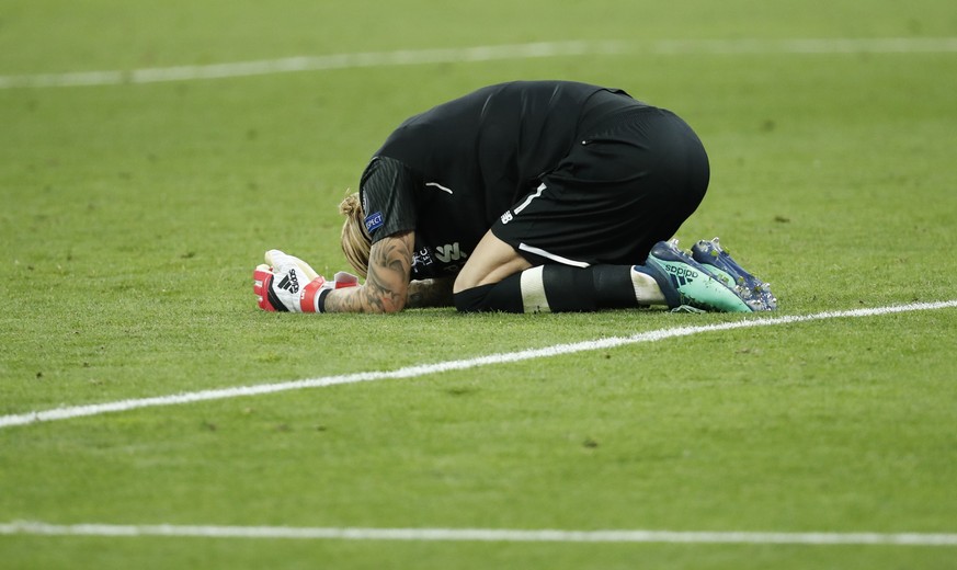 Liverpool goalkeeper Loris Karius kneels on the pitch at the end of the Champions League Final soccer match between Real Madrid and Liverpool at the Olimpiyskiy Stadium in Kiev, Ukraine, Saturday, May ...