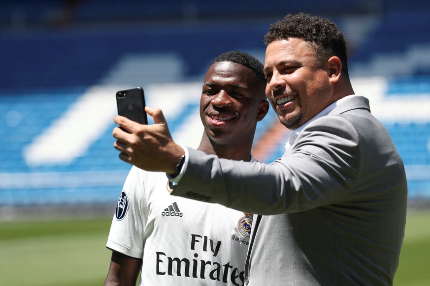 Soccer Football - Real Madrid presents new Brazilian teenager Vinicius Junior - Bernabeu Stadium, Madrid, Spain - July 20, 2018 Brazilian teenager Vinicius Junior, 18, poses for a selfie with former R ...