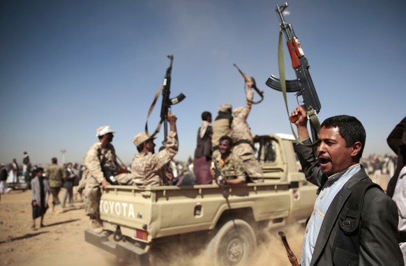 FILE - In this Jan. 3, 2017, file photo, a tribesman loyal to the Houthi rebels, right, chants slogans during a gathering aimed at mobilizing more fighters into battlefronts to fight pro-government fo ...