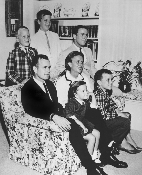 FILE - In this 1964 file photo, George H.W. Bush sits on couch with his wife, Barbara, and their children. George W. Bush sits at right behind his mother. Behind couch are Neil and Jeb Bush. Sitting w ...