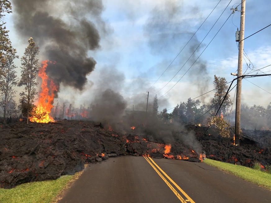 Lava advances along a street near a fissure in Leilani Estates, on Kilauea Volcano&#039;s lower East Rift Zone, Hawaii, the U.S., May 5, 2018. U.S. Geological Survey/Handout via REUTERS THIS IMAGE HAS ...