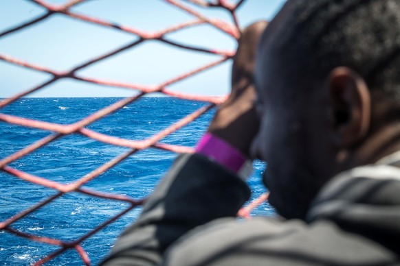 A migrant looks out at the water, onboard the Sea Watch 3 German charity ship, off the coast of Lampedusa, Italy May 19, 2019. Picture taken May 19, 2019. Nick Jaussi/Sea-Watch/Handout via REUTERS ATT ...