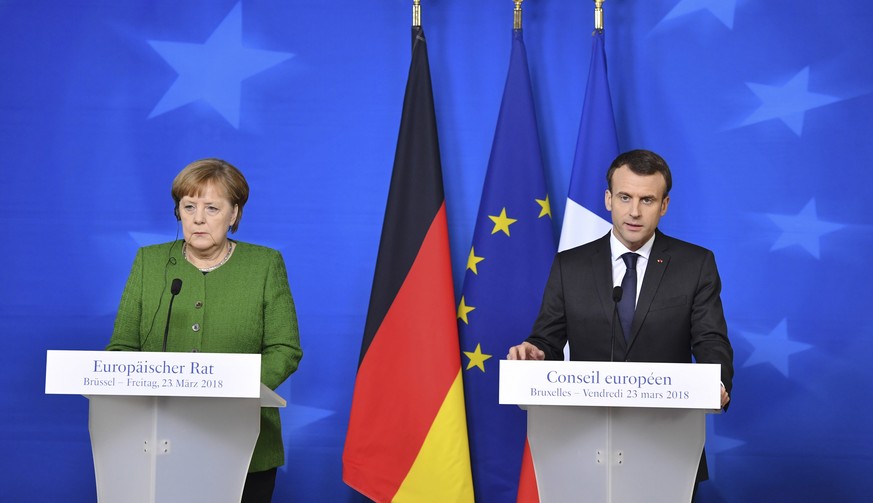French President Emmanuel Macron, right, and German Chancellor Angela Merkel participate in a media conference at the conclusion of an EU summit in Brussels on Friday, March 23, 2018. (Geert Vanden Wi ...