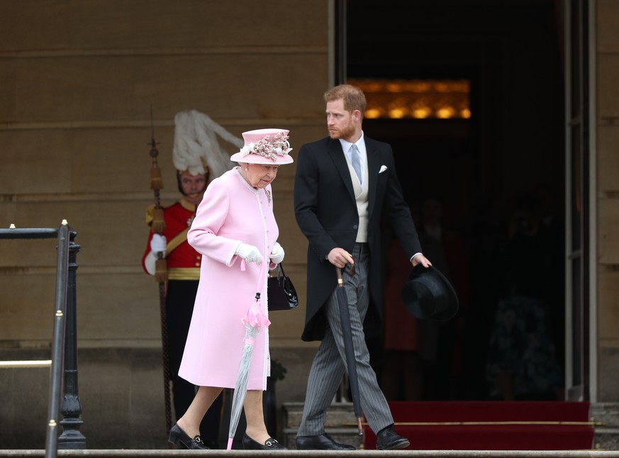 LONDON, ENGLAND - MAY 29: Queen Elizabeth II and Prince Harry, Duke of Sussex attend the Royal Garden Party at Buckingham Palace on May 29, 2019 in London, England. (Photo by Yui Mok - WPA Pool/Getty  ...
