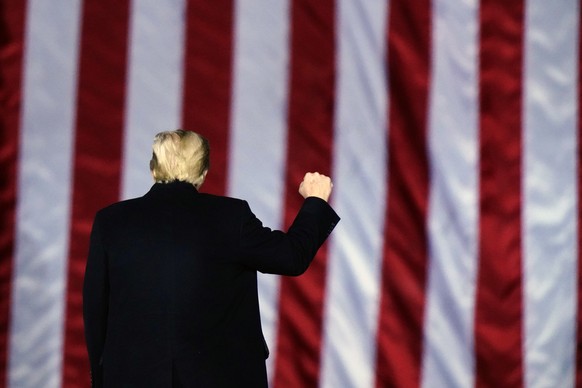 FILE - In this Monday, Jan. 4, 2021, file photo, President Donald Trump gestures at a campaign rally in support of Senate candidates Sen. Kelly Loeffler, R-Ga., and David Perdue in Dalton, Ga. Trump w ...