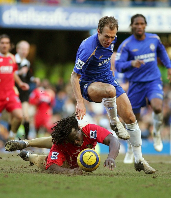 Arjen Robben (C) of Chelsea hops over Linvoy Primus (on ground) of Portsmouth during their English Premier League clash between Chelsea FC and Portsmouth FC played at Chelsea&quot;s Stamford Bridge st ...