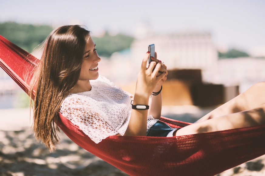 Smiling girl taking selfies beach lying hammock, Smart Phone, Summer holiday vacation scene