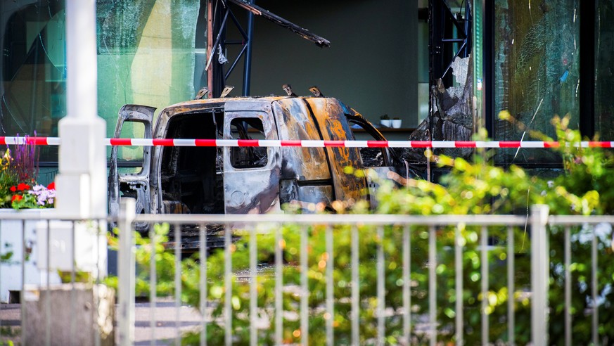 A van is seen burned out after crashing into the glass facade of the head office of Dutch newspaper De Telegraaf in what police said was a deliberate action in Amsterdam, Netherlands June 26, 2018. RE ...