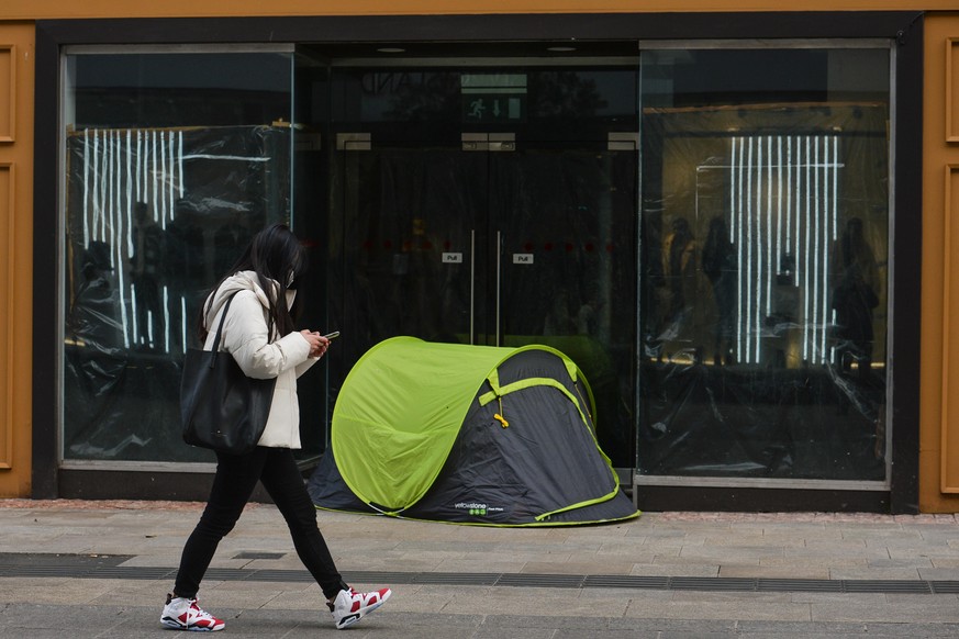 A young woman walks past a rough sleeper&#039;s tent on Grafton Street in Dublin city center during Level Five Covid-19 lockdown. 
On Monday, March 1, 2021, in Dublin, Ireland. (Photo by Artur Widak/N ...