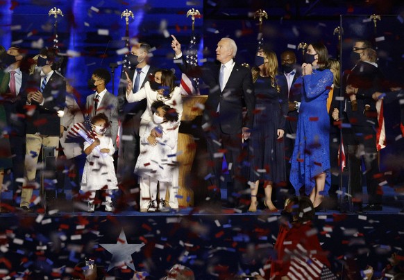 Democratic 2020 U.S. presidential nominee Joe Biden, vice presidential nominee Kamala Harris and their families celebrate at their election rally, after the news media announced that Biden has won the ...