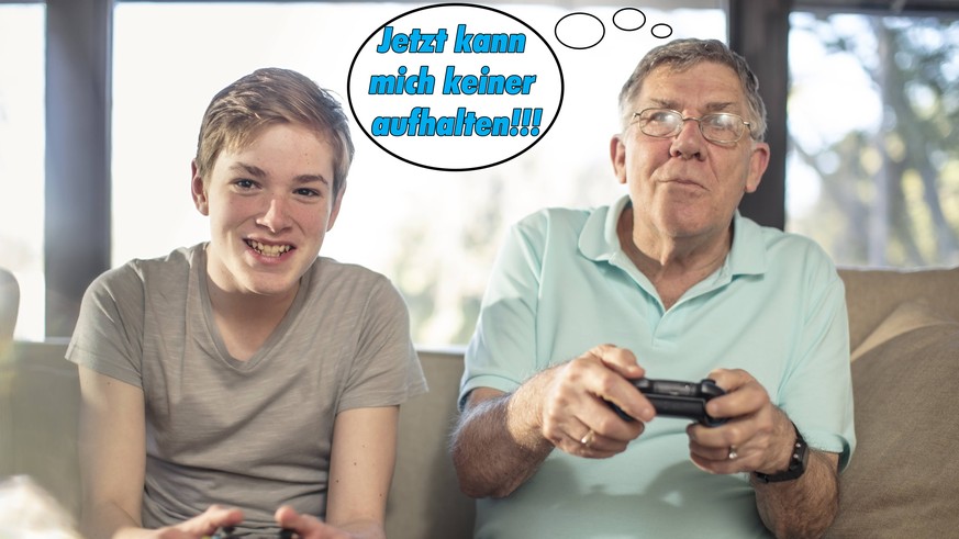 Grandfather and grandson playing video game on couch at home model released Symbolfoto property released PUBLICATIONxINxGERxSUIxAUTxHUNxONLY ZEF14779