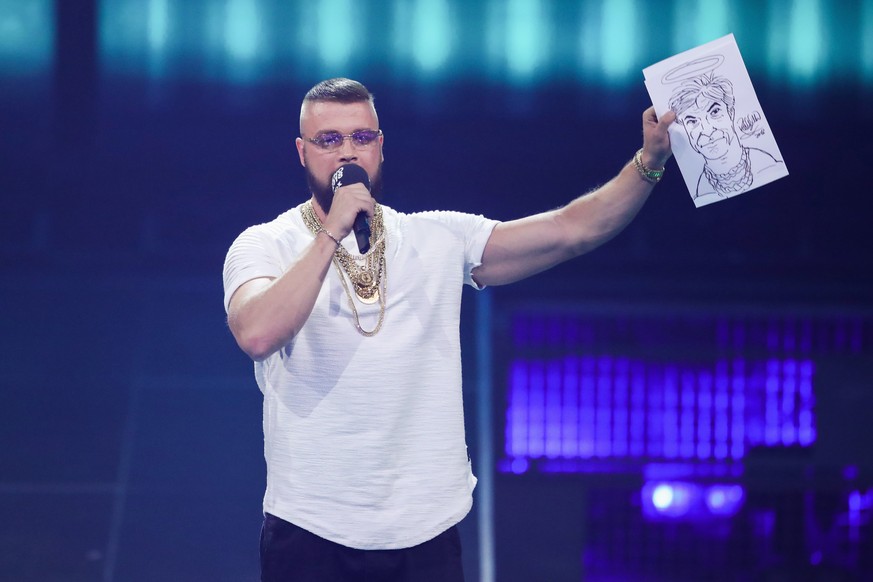 BERLIN, GERMANY - APRIL 12: &#039;Hip-Hop/Urban - National&#039; award winner Kollegah speaks on stage during the Echo Award show at Messe Berlin on April 12, 2018 in Berlin, Germany. (Photo by Andrea ...