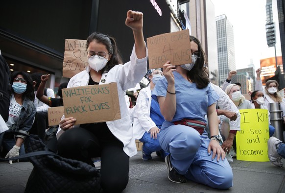 Healthcare workers gather in Times Square for the 7pm daily &quot;Thank You Hour&quot; to honor essential medical workers and to protest on Blackout Tuesday and another night of unrest in Manhattan as ...
