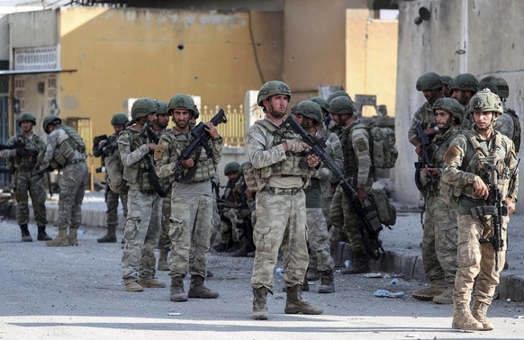 Turkish soldiers secure in Syrian town of Ras al Ayn, northeastern Syria, Wednesday, Oct. 23, 2019. Turkish media reports say Turkish troops and their allied Syrian opposition forces are securing a to ...