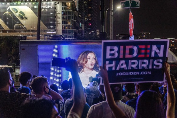 November 7, 2020, Miami, United States: Supporters of Joe Biden gather on Biscayne Boulevard to watch the President Elect and Vice President Elect Kamala Harris address the nation with victory speech  ...