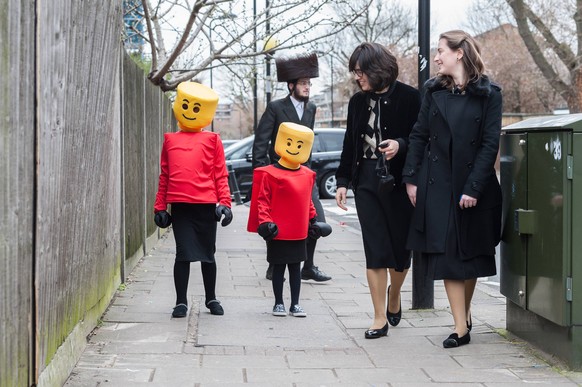 March 21, 2019 - London, England, United Kingdom - Jewish children in fancy Lego costume take part in the annual holiday of Purim on the streets of Stamford Hill in London on 21 March, 2019. The festi ...