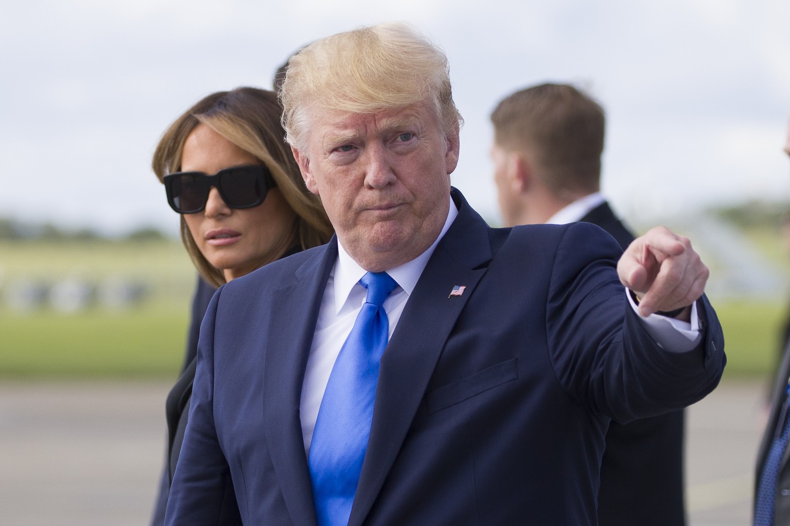 President Donald Trump, with first lady Melania Trump, points as they arrive at Shannon Airport, Thursday, June 6, 2019, in Shannon, Ireland. (AP Photo/Alex Brandon)