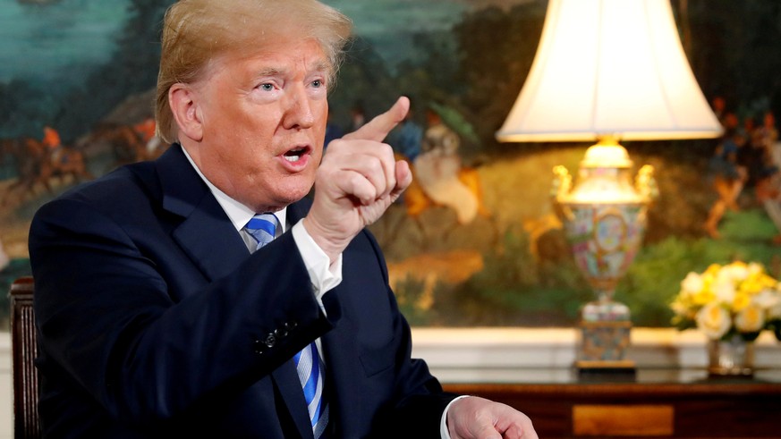 FILE PHOTO: U.S. President Donald Trump speaks to reporters after signing a proclamation declaring his intention to withdraw from the JCPOA Iran nuclear agreement in the Diplomatic Room at the White H ...