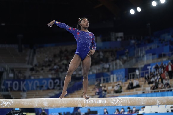 Simone Biles, of the United States, performs on the balance beam during the women&#039;s artistic gymnastic qualifications at the 2020 Summer Olympics, Sunday, July 25, 2021, in Tokyo. (AP Photo/Ashle ...