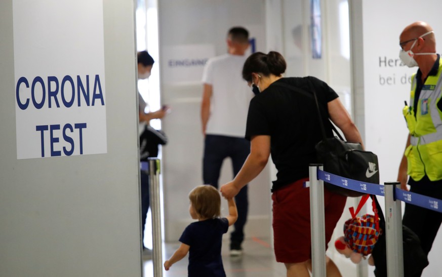Travellers enter the new Corona Test Centre at Duesseldorf Airport in Duesseldorf, Germany, July 27, 2020. Travellers can make a voluntary test for the coronavirus disease (COVID-19) following their a ...