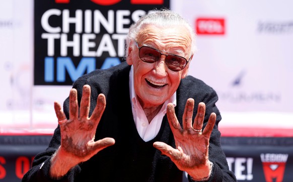 Marvel Comics co-creator Stan Lee shows his hands after placing them in cement during a ceremony in the forecourt of the TCL Chinese theatre in Los Angeles, California, U.S., July 18, 2017. REUTERS/Ma ...