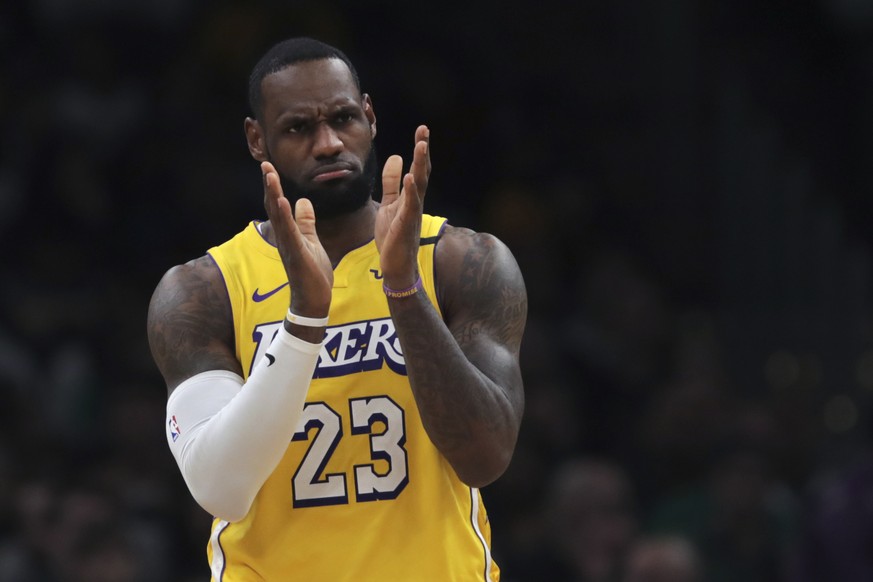 Los Angeles Lakers forward LeBron James applauds his teammates during the first half of an NBA basketball game against the Boston Celtics in Boston, Monday, Jan. 20, 2020. (AP Photo/Charles Krupa)