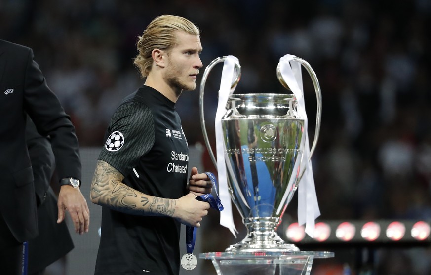 Liverpool goalkeeper Loris Karius walks past the trophy after the Champions League Final soccer match between Real Madrid and Liverpool at the Olimpiyskiy Stadium in Kiev, Ukraine, Saturday, May 26, 2 ...