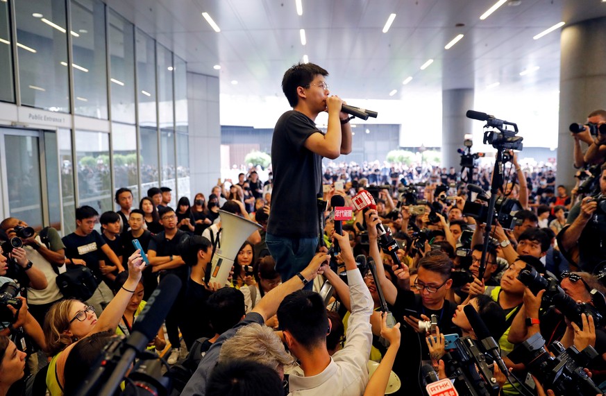 FILE PHOTO: Pro-democracy activist Joshua Wong addresses the crowds outside the Legislative Council during a demonstration demanding Hong Kong&#039;s leaders step down and withdraw the extradition bil ...