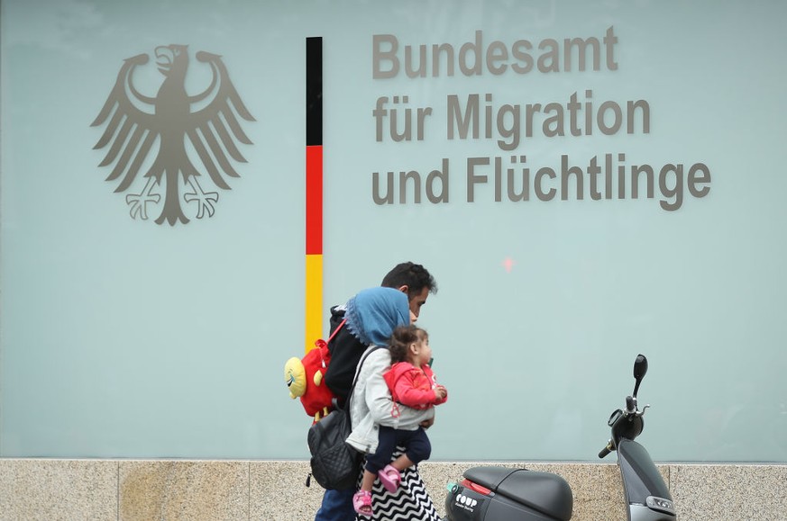 BERLIN, GERMANY - MAY 18: A family walks past the Berlin office of the Federal Agency for Migration and Refugees, also known as BAMF (Bundesamt fuer Migration und Fluechtlinge) on May 18, 2018 in Berl ...
