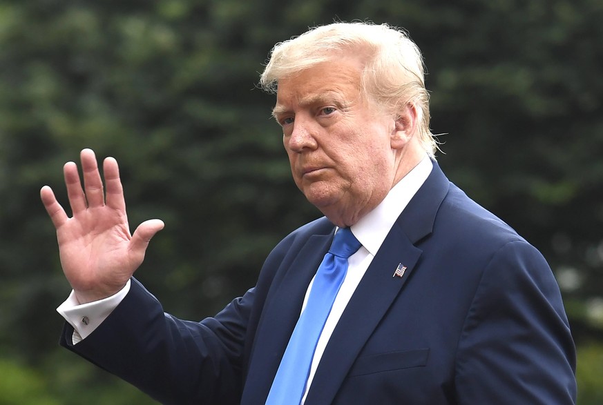 United States President Donald J. Trump waves to the press as he returns to the White House in Washington, DC after a visit to Walter Reed National Military Medical Center, in Bethesda Maryland, where ...