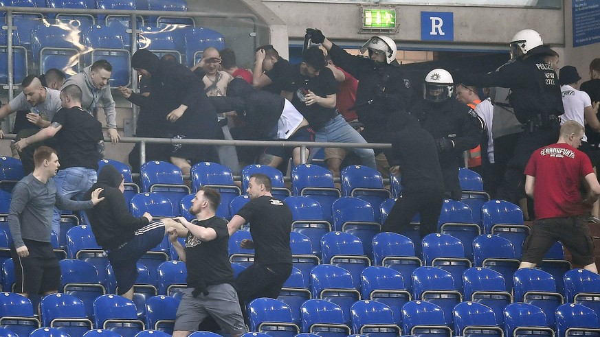 Supporters from Schalke and Frankfurt fight on the tribune after the German soccer cup semifinal match between FC Schalke 04 and Eintracht Frankfurt in Gelsenkirchen, Germany, Wednesday, April 18, 201 ...