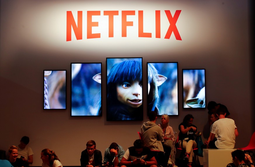 FILE PHOTO: Gamers and visitors take a rest at the booth of Netflix during Europe&#039;s leading digital games fair Gamescom, which showcases the latest trends of the computer gaming scene in Cologne, ...
