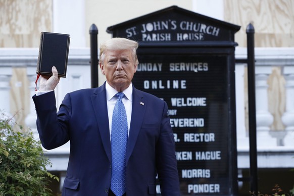 President Donald Trump holds a Bible as he visits outside St. John&#039;s Church across Lafayette Park from the White House Monday, June 1, 2020, in Washington. Park of the church was set on fire duri ...