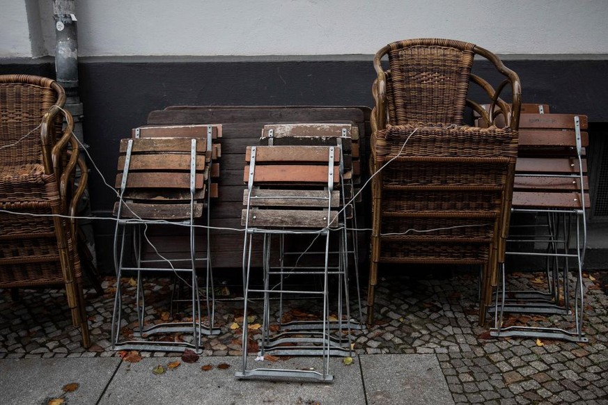 BERLIN, GERMANY - OCTOBER 15: Chairs are stacked together outside a restaurant on October 15, 2020 in Berlin, Germany. Due to the significant increase in coronavirus infections, most stores and all re ...