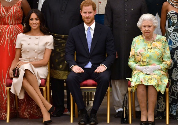 FILE PHOTO: Britain&#039;s Queen Elizabeth, Prince Harry and Meghan, the Duchess of Sussex, pose for a picture at in London, Britain June 26, 2018. John Stillwell/Pool via Reuters/File Photo