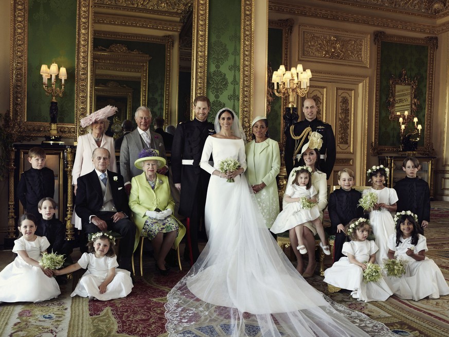 In this photo released by Kensington Palace on Monday May 21, 2018, shows an official wedding photo of Britain&#039;s Prince Harry and Meghan Markle, center, in Windsor Castle, Windsor, England, Satur ...
