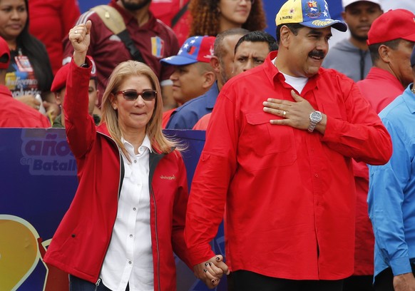 Venezuela&#039;s President Nicolas Maduro and first lady Cilia Flores acknowledge supporters at the end of a rally in Caracas, Venezuela, Saturday, Feb. 2, 2019. Maduro called the rally to celebrate t ...